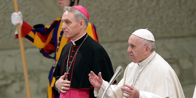 Pope Francis flanked by Monsignor Georg Gaenswein blesses the faithful on the occasion of the weekly general audience, at the Vatican, Wednesday, Dec. 19, 2018. (AP Photo/Gregorio Borgia)