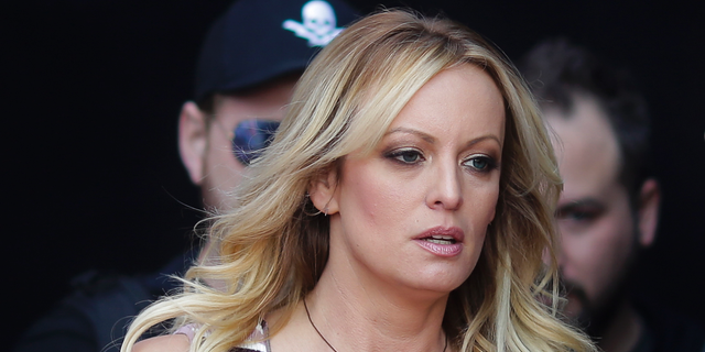 FILE - In this Oct. 11, 2018, file photo, adult film actress Stormy Daniels arrives for the opening of the adult entertainment fair "Venus," in Berlin.  (AP Photo/Markus Schreiber, File)