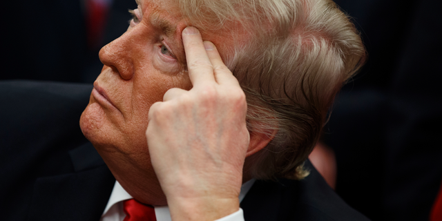 President Donald Trump listens during a signing ceremony for the "First Step Act" and "Juvenile Justice Reform Act," in the Oval Office of the White House, Friday, Dec. 21, 2018, in Washington. (AP Photo/Evan Vucci)