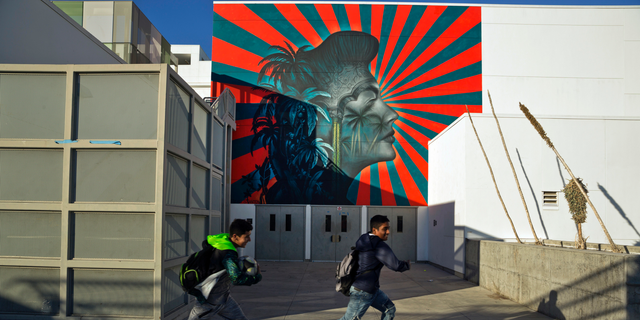 FILE - In this Dec. 13, 2018 file photo, a mural by artist Beau Stanton of actress Ava Gardner is displayed at the Robert F. Kennedy Community Schools complex school in Los Angeles. Artist Shepard Fairey will insist that one of his murals be removed from the Los Angeles school if officials follow through on plans to cover up Stanton's mural that some community activists find offensive, the Los Angeles Times reported Monday, Dec. 17, 2018. Both murals are in Koreatown at the Robert F. Kennedy Schools complex on the former site of the Ambassador Hotel where Kennedy was fatally shot in 1968. Stanton's mural depicts actress Ava Gardner against sun rays. Korean activists say it looks like the Japanese imperial battle flag. (AP Photo/Damian Dovarganes, File)