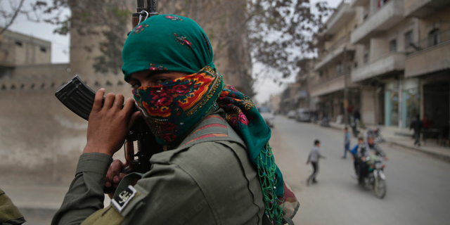 A member of the Kurdish internal security forces on a patrol in Manbij, north Syria, in March 2018. (AP Photo/Hussein Malla, File)