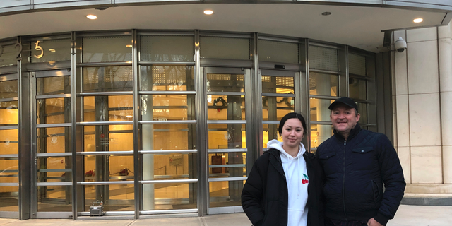 In this Dec. 3, 2018 photo, Australian tourists Wayne Burg and his daughter Lydia stand in front of Brooklyn's federal courthouse in New York, where they were viewing the trial of Mexican drug trafficker Joaquin "El Chapo" Guzman. Burg is a criminal lawyer in his home country and said he did not want to miss the chance to witness one day in the trial of "El Chapo." (AP Photo/Claudia Torrens)