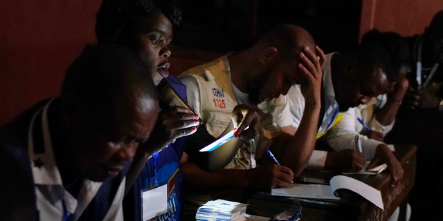 Electoral commission officials tally the presidential ballots in Kinshasa, Sunday Dec. 30, 2018. Forty million voters were registered for a presidential race plagued by years of delay and persistent rumors of lack of preparation. (AP Photo/Jerome Delay)