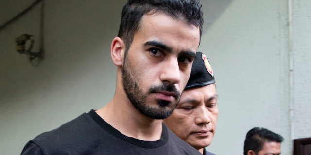 FILE - In this Tuesday, Dec. 11, 2018, file photo, Thai prison guards lead Bahraini football player Hakeem al-Araibi from court in Bangkok, Thailand. Human rights groups and former soccer players on Saturday, Dec. 22, 2018, in Melbourne, Australia, have called on FIFA and the Australian government to intervene to stop a Melbourne-based refugee and semi-professional soccer player Hakeem from being extradited from Thailand to Bahrain. (AP Photo/Gemunu Amarasinghe, File)