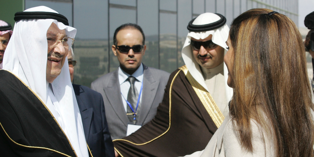 FILE - In this Feb. 24, 2010 file photo, Saudi Prince Talal bin Abdelaziz, left, receives Queen Rania of Jordan during the opening ceremony of the Arab Open University, Jordan branch, in Amman, Jordan. Abdulaziz, a senior member of the royal family who supported women's rights and once led a group of dissident princes, has died at the age of 87. Prince Talal was an older brother to King Salman and the father of businessman Prince Alwaleed bin Talal. The royal court said prayers for Prince Talal, who died on Saturday, will be held in Riyadh on Sunday, Dec. 23, 2018. (AP Photo/Nader Daoud, File)