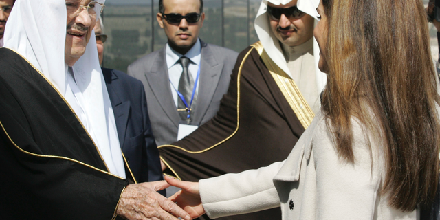 FILE - In this Feb. 24, 2010 file photo, Saudi Prince Talal bin Abdelaziz, left, receives Queen Rania of Jordan during the opening ceremony of the Arab Open University, Jordan branch, in Amman, Jordan. Abdulaziz, a senior member of the royal family who supported women's rights and once led a group of dissident princes, has died at the age of 87. Prince Talal was an older brother to King Salman and the father of businessman Prince Alwaleed bin Talal. The royal court said prayers for Prince Talal, who died on Saturday, will be held in Riyadh on Sunday, Dec. 23, 2018. (AP Photo/Nader Daoud, File)