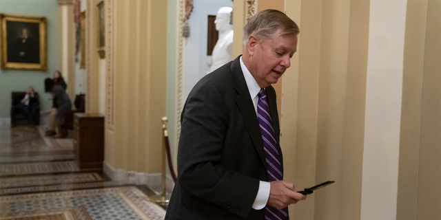 Sen. Lindsey Graham, R-S.C., a member of the Senate Armed Services Committee, rushes to the office of Senate Majority Leader Mitch McConnell, R-Ky., at day's end on Capitol Hill in Washington, Wednesday, Dec. 19, 2018. Amid the news that President Donald Trump is pulling all 2,000 U.S. troops out of Syria, Graham said he was "blindsided" by the report and called the decision "a disaster in the making." (AP Photo/J. Scott Applewhite)