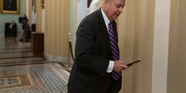 Sen. Lindsey Graham, R-S.C., a member of the Senate Armed Services Committee, rushes to the office of Senate Majority Leader Mitch McConnell, R-Ky., at day's end on Capitol Hill in Washington, Wednesday, Dec. 19, 2018. Amid the news that President Donald Trump is pulling all 2,000 U.S. troops out of Syria, Graham said he was "blindsided" by the report and called the decision "a disaster in the making." (AP Photo/J. Scott Applewhite)