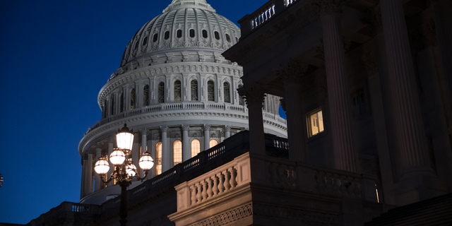 The Capitol is seen at day's end as the Senate works on a House-passed bill that would pay for President Donald Trump's border wall and avert a partial government shutdown, at the Capitol in Washington, Friday, Dec. 21, 2018. (AP Photo/J. Scott Applewhite)