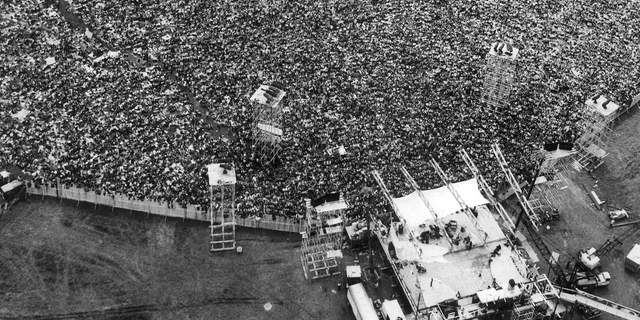 Music fans pack around the stage at the original Woodstock Music and Arts Festival, lower right, in Bethel, N.Y., on August 16, 1969.
