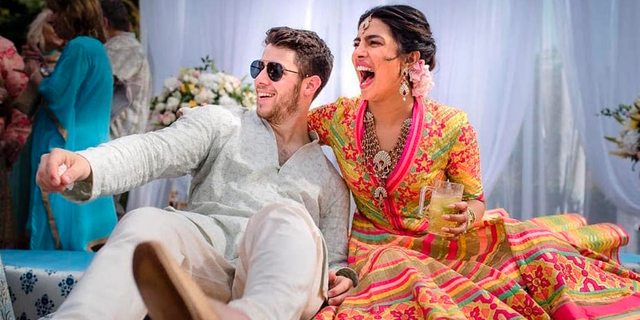 Priyanka Chopra and Nick Jonas celebrate during a mehendi ceremony, a day before their wedding, at Umaid Bhawan in Jodhpur, India.