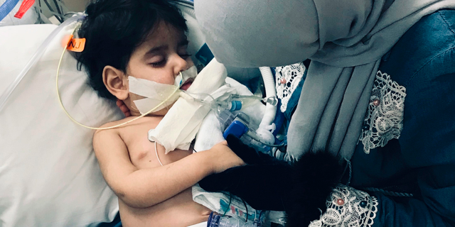 In this December 2018 photo released by the Council on American Islamic Relations, Sacramento Valley, Shaima Swileh, of Yemen, holds her dying 2-year old son Abdullah Hassan at UCSF Benioff Children's Hospital in Oakland, Calif. USA. The Council on American-Islamic Relations announced Friday, Dec. 28, 2018, that Abdullah died at the Oakland hospital, where his father Ali Hassan brought him in the fall to get treatment for a genetic brain disorder. Swileh, who is not an American citizen, sued the Trump administration to let her into the country to be with the ailing boy. (Council on American Islamic Relations, Sacramento Valley via AP)