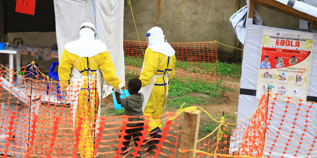 Health workers walk with a boy suspected as having the Ebola virus in Beni, Eastern Congo, in this file photo dated Sept. 9, 2018.
