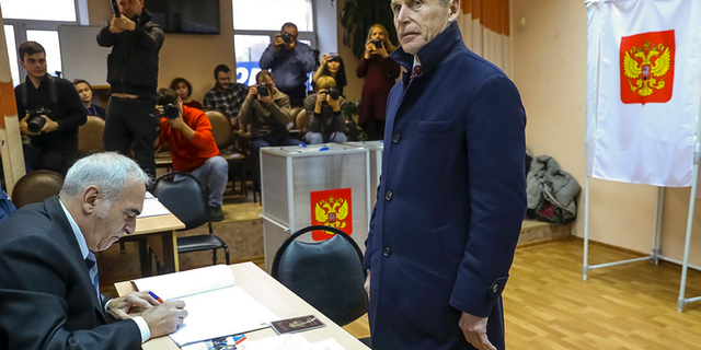 Oleg Kozhemyako, acting governor of the far eastern region of Primorsky Krai stands as he waits to get his ballot at a polling station in Vladivostok, Russia, Sunday, Dec. 16, 2018. Russians living in the far eastern region of Primorsky Krai cast their votes Sunday for a new governor in a tightly watched election, with Kozhemyako reported to be leading the vote. (Igor Novikov, Governor and Administration of Primorye Territory press service via AP)