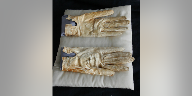 FILE - This June 14, 2007 file photo shows, Abraham Lincoln's bloodstained gloves he carried on the night of his death at the Abraham Lincoln Presidential Library and Museum in Springfield, Ill. Historians say that the 2007 acquisition of 1,500 documents and artifacts for the Abraham Lincoln Presidential Library and Museum firmly established Illinois as a leading repository of all things Lincoln. So forgive the handwringing over the possibility that some of it might have to be sold. The Lincoln museum's fundraising foundation, which borrowed $23 million in 2007 to buy the trove from private collector Louise Taper, still owes $9.2 million on a note due in October 2019. (AP Photo/Seth Perlman File)