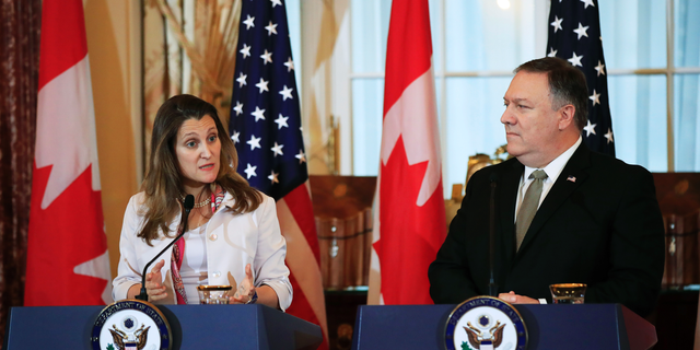 Canadian Minister of Foreign Affairs Chrystia Freeland, left, with Secretary of State Mike Pompeo, speaks to reporters during a news conference at the State Department in Washington, Friday, Dec. 14, 2018. (AP Photo/Manuel Balce Ceneta)