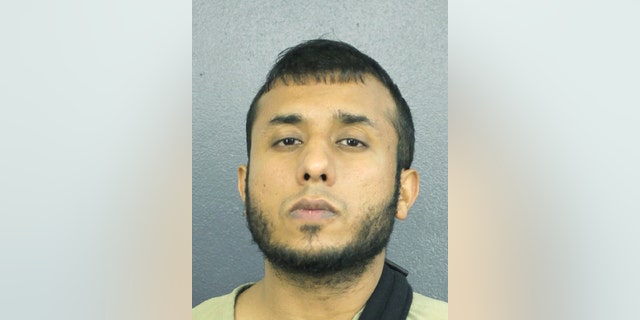 This Dec. 14, 2018 photo made available by the Broward County Sheriff's Office, Fla., shows Tayyab Tahir Ismail under arrest. An FBI affidavit unsealed Monday, Dec. 17, 2018, charges Ismail with posting detailed bomb-making instructions to online sites frequented by extremists such as supporters of the Islamic State group. (Broward County Sheriff's Office via AP)