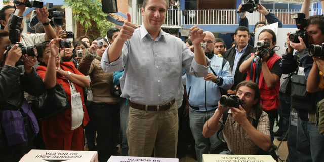 FILE - In this July 4, 2010 file photo, Rafael Moreno Valle, candidate of the "Compromiso por Puebla" party coalition, flashes two thumbs up after casting his vote during state elections in Puebla, Mexico. Moreno Valle, who went on to win the 2010 gubernatorial race, died in what local media are reporting as a helicopter crash on Christmas Eve, Monday, Dec. 24, 2018, along with his wife Martha Erika Alonso, who is currently the governor of Puebla. (AP Photo/Joel Merino, File)