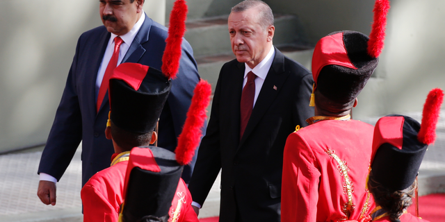 Venezuela's President Nicolas Maduro receives Turkey's President Recep Tayyip Erdogan at the Miraflores Presidential Palace in Caracas, Venezuela, Monday, Dec. 3, 2018. Erdogan is on a one-day official visit to the country. (AP Photo/Ariana Cubillos)