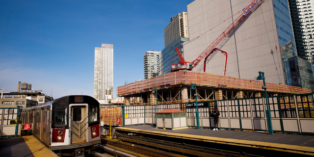FILE - In this Nov. 7, 2018, file photo, a construction crane is perched on the site of Court Square City View Tower adjacent to the Court Square Number 7 subway station in Long Island City in the Queens borough of New York. U.S. developers broke ground on more homes for November, but the increase occurred entirely in apartments. The construction of new single-family houses fell. (AP Photo/Mark Lennihan, File)