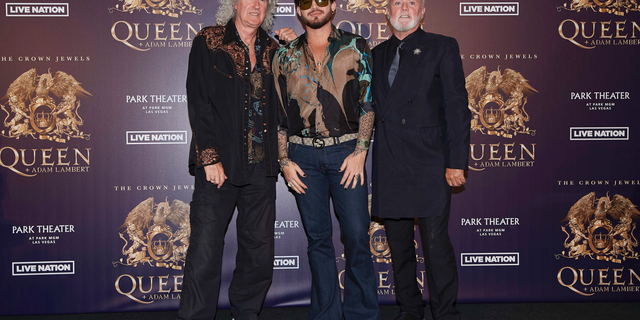 Brian May, from left, Adam Lambert, and Roger Taylor of Queen + Adam Lambert pose for a photo at the "The Crown Jewels" residency press conference at the MGM Resorts aviation hanger in Las Vegas.