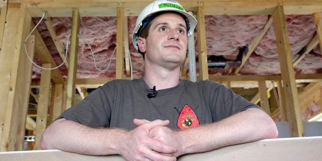 Democratic congressional candidate Dan McCready leans against wallboard as he pauses during a Habitat For Humanity building event in Charlotte, N.C.
