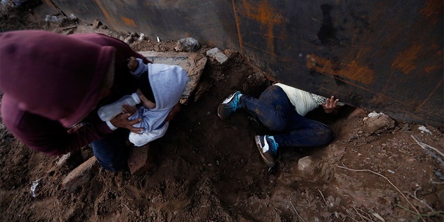 Moments later, Martinez surrendered to waiting border guards while Mendez stayed behind in Tijuana to work, saying he feared he'd be deported if he crossed. (AP Photo/Rebecca Blackwell)