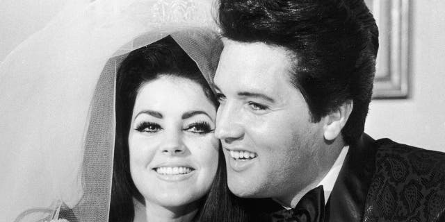 1st May 1967: American rock musician Elvis Presley (1935 - 1977) and his wife, Priscilla Beaulieu Presley, hugging each other on their wedding day, Las Vegas, Nevada. Priscilla wears her bridal gown and veil, and Elvis wears a shiny paisley jacket. (Photo by Hulton Archive/Getty Images)
