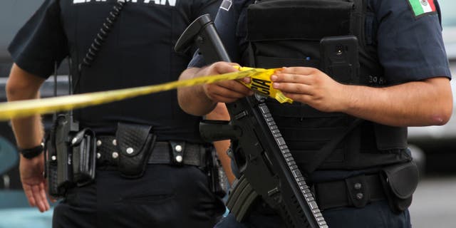Police officers are pictured at a crime scene in Zapopan, state of Jalisco, Mexico on July 31, 2018 (Photo by ULISES RUIZ/AFP/Getty Images)