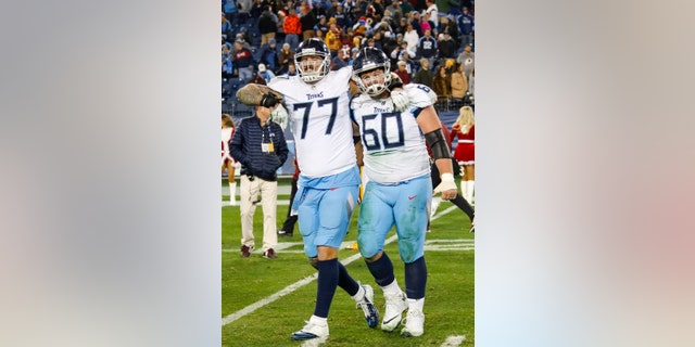 Taylor Lewan #77 of the Tennessee Titans hugs Ben Jones #60 after a victory over the Washington Redskins at Nissan Stadium on December 22, 2018 in Nashville, Tennessee. (Photo by Frederick Breedon/Getty Images)