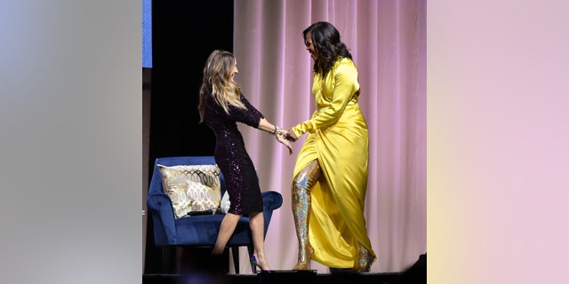 NEW YORK, NEW YORK - DECEMBER 19: Former first lady Michelle Obama (R) discusses her book "Becoming" with Sarah Jessica Parker at Barclays Center on December 19, 2018 in New York City. (Photo by Dia Dipasupil/Getty Images)