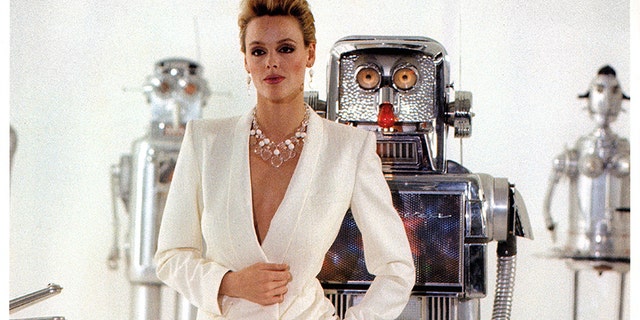 Brigitte Nielsen standing in front of robots in a scene from the film "Cobra," 1986. — Getty