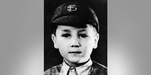 Headshot portrait of British musician and songwriter John Lennon (1940 -1980), of the pop group The Beatles, as a young boy in a school uniform and cap, c. 1948.