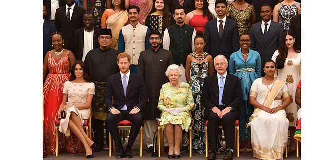 A family affair! Meghan and Harry sit next to Queen Elizabeth II and John Major at the Queen's Young Leaders Awards Ceremony at Buckingham Palace on June 26, 2018 in London, England.