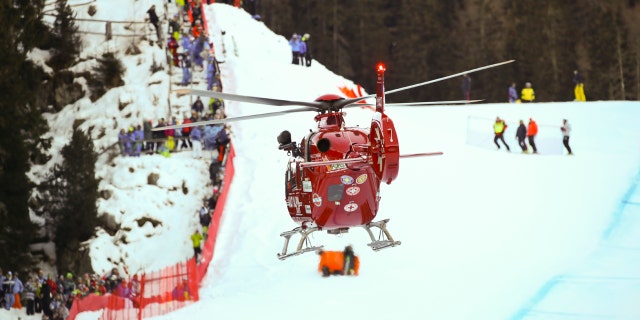A rescue helicopter leaves with on board Switzerland's Marc Gisin after he crashed on the course during a men's World Cup downhill, in Val Gardena, Italy, Saturday, Dec. 15, 2018.