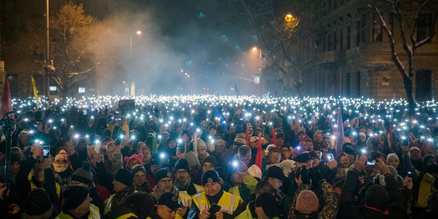 Anti-government demonstrators lighting up their phones during their protest in downtown Budapest on Sunday. (Zoltan Balogh/MTI via AP)