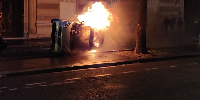 Protesters set a car on fire Saturday evening after a day of clashes with police.