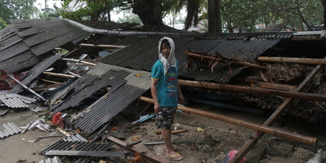 A man inspects his house which was damaged by a tsunami, in Carita, Indonesia, Sunday, Dec. 23, 2018. (Associated Press)