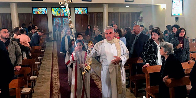 Iraqis attend Christmas Mass at Mar Youssif Chaldean Church, in Baghdad, Iraq, Tuesday, Dec. 25, 2018. Although the number of Christians has dropped in Iraq, Christmas, a national holiday, is very popular in the capital. (AP Photo/Ali Abdul Hassan)