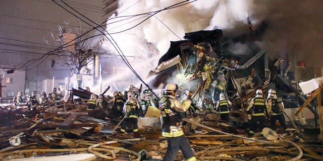 Firefighters operate at the site where a large explosion occurred at a restaurant in Sapporo, Hokkaido, northern Japan, in this photo taken by Kyodo December 16, 2018.