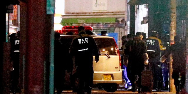 A car is inspected by police after it injured several pedestrians in Tokyo, early Tuesday, Jan. 1, 2019. A car slammed into pedestrians early Tuesday on a street where people had gathered for New Year's festivities in downtown Tokyo. (Yuta Omori/Kyodo News via AP)
