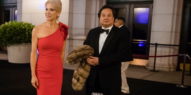 In this Thursday, Jan. 19, 2017 photo, President-elect Donald Trump adviser Kellyanne Conway, center, accompanied by her husband, George.