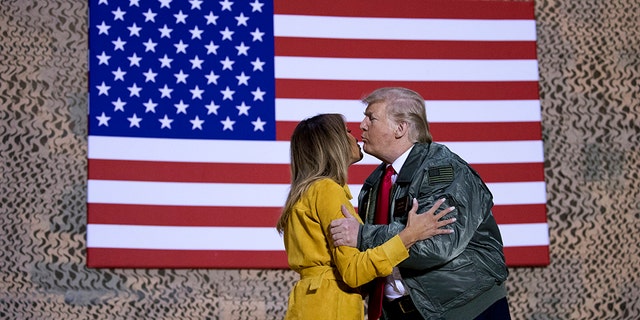 President Trump and the first lady during a hangar rally at Al Asad Air Base, Iraq, Wednesday. (AP Photo/Andrew Harnik)