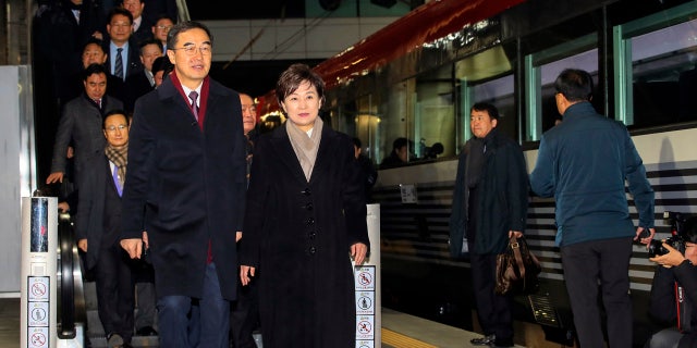 South Korean Unification Minister Cho Myoung-gyon, bottom left, and officials arrive to board a train to leave for North Korea at the Seoul Railway Station in Seoul, South Korea, Wednesday, Dec. 26, 2018. (Jin Sung-chul/Yonhap via AP)
