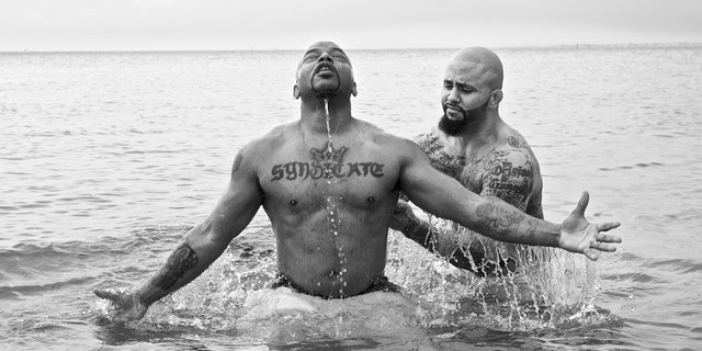 Rene "Level" Martinez baptizing his friend, Corey, who used to be in the gang Latin Syndicate with him.
