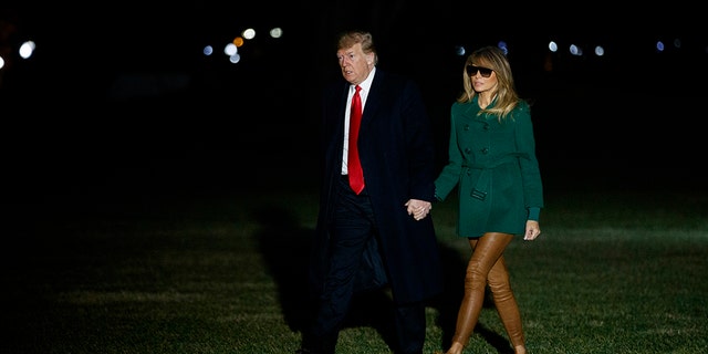 President Donald Trump and first lady Melania Trump arrive on the South Lawn of the White House after making a surprise visit to troops in Iraq, Thursday, Dec. 27, 2018, in Washington. (AP Photo/Evan Vucci)