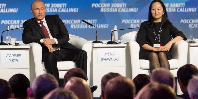 Russia's President Vladimir Putin (L) and Meng Wanzhou in Moscow, Russia, in 2014.