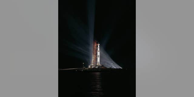 Searchlights penetrate the darkness surrounding Apollo 8 on Pad 39-A at Kennedy Space Center.