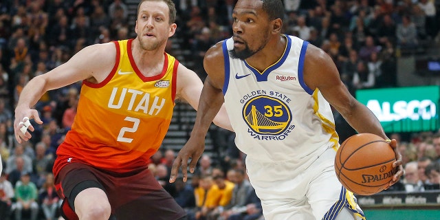 Golden State Warriors forward Kevin Durant (35) drives around Utah Jazz forward Joe Ingles (2) in the first half during an NBA basketball game Wednesday Dec. 19, 2018, in Salt Lake City. (Associated Press)