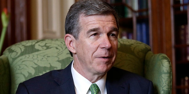 North Carolina Gov. Roy Cooper's veto of a new voter ID bill was overridden by the state's Republican lawmakers on Wednesday. (AP Photo/Gerry Broome)